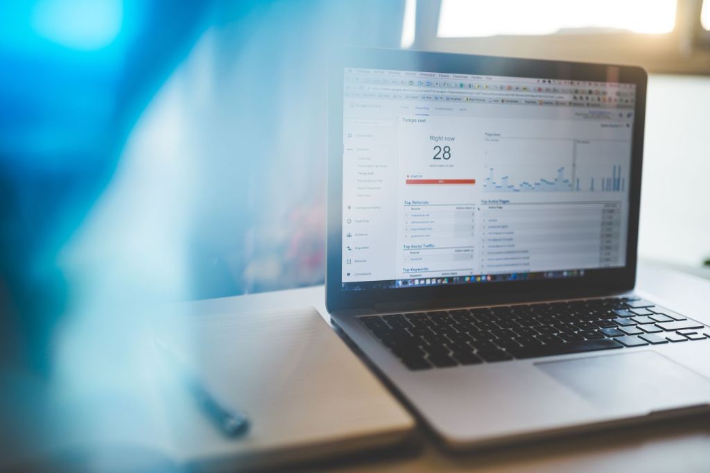 Real estate agent using a laptop for email marketing campaigns